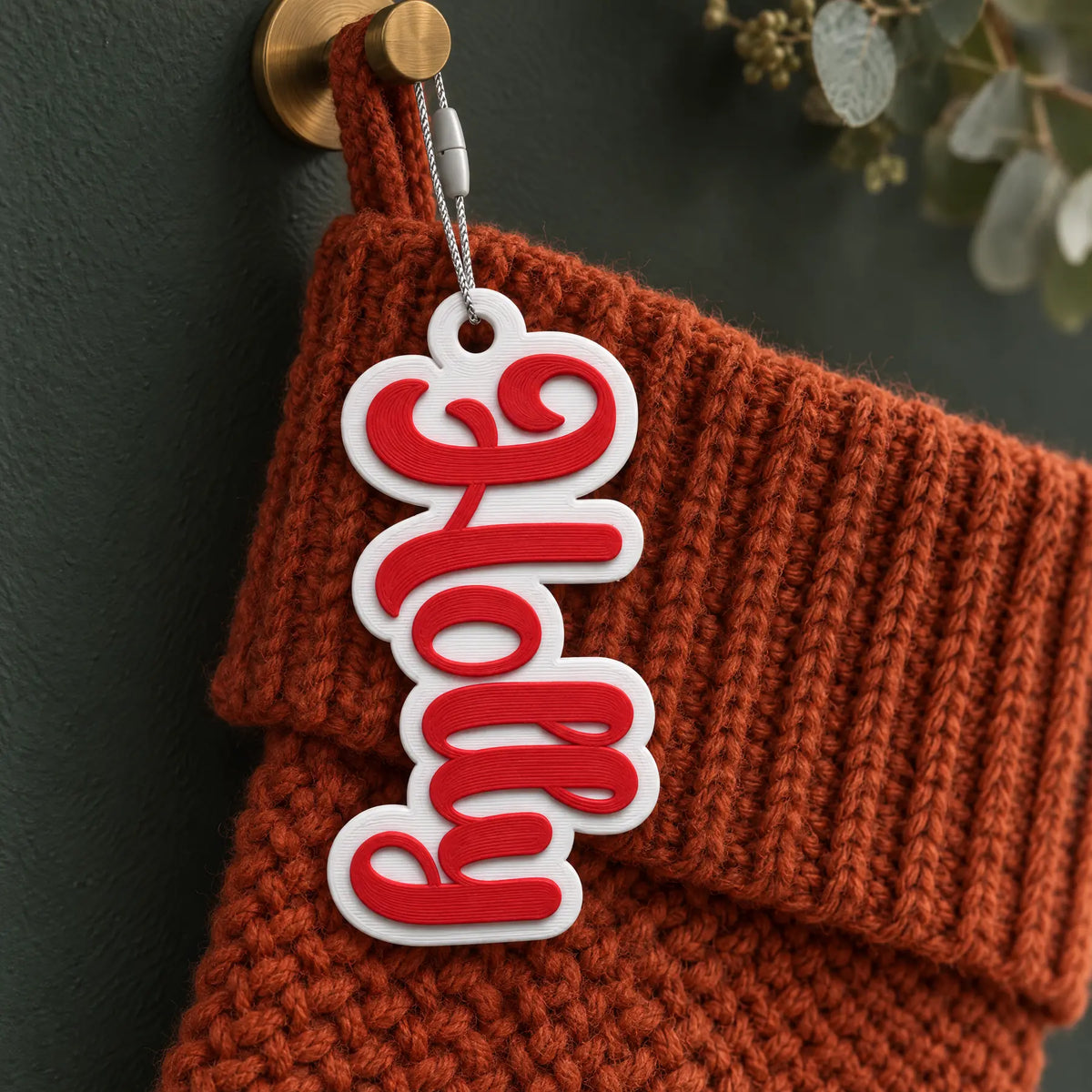 Bubble Script Christmas Stocking Name Tag: red bubble script on a white backing, name Holly, on a knit Christmas stocking