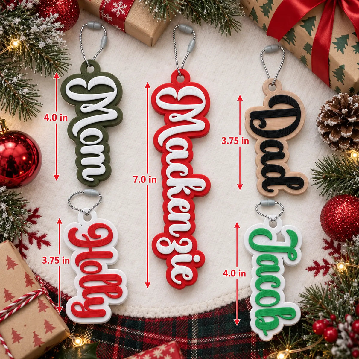 Flat lay of Bubble Script stocking name tags with ornaments, showing how tag length changes with each name