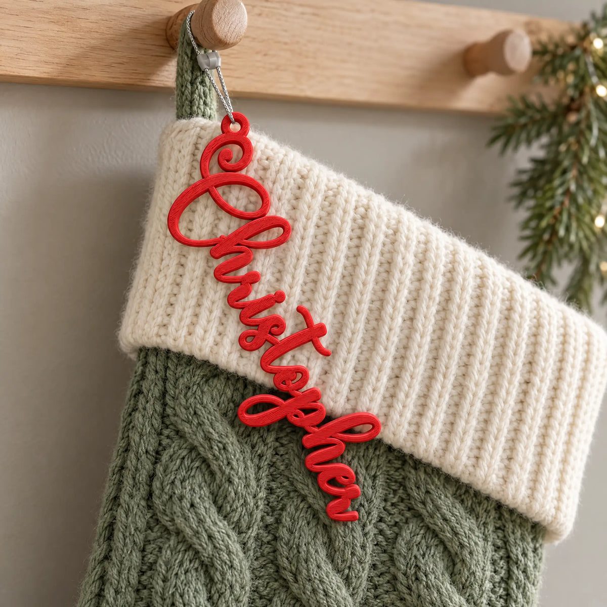 Elegant Script Christmas Stocking Name Tag: thin red script in one color, name Christopher, on a knit Christmas stocking