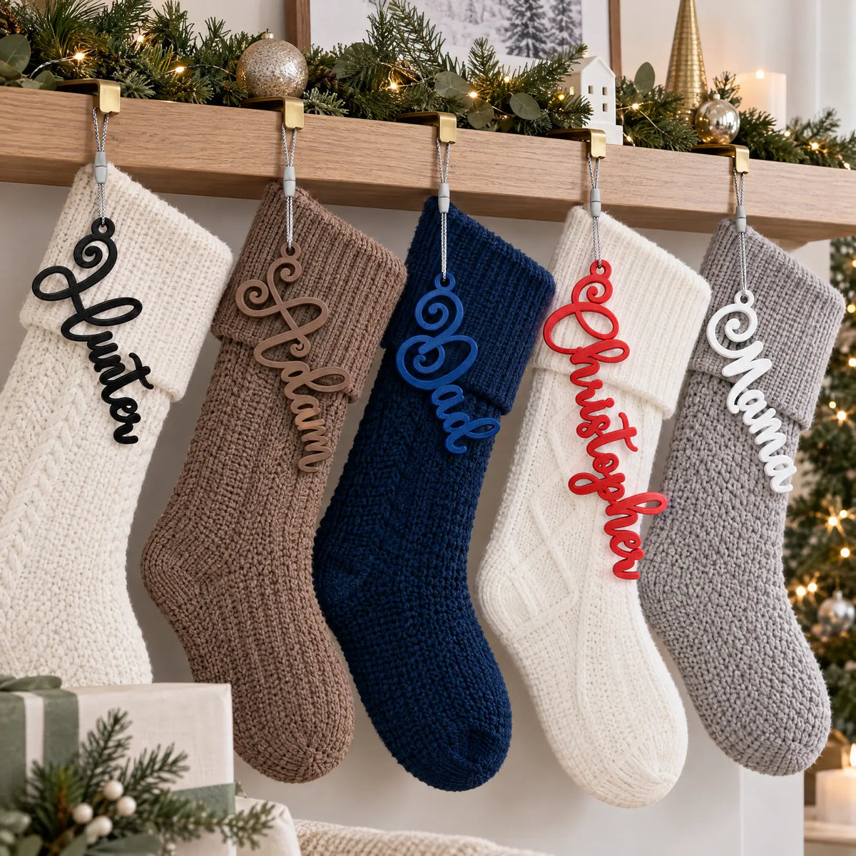 Elegant Script stocking name tags on a row of Christmas stockings along a mantel with a decorated tree