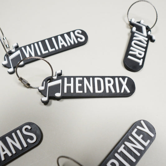 Personalized band keychain with music notes and custom name — photo 1